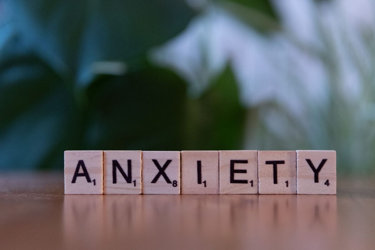 Close-up of wooden blocks spelling ANXIETY on a wooden surface