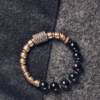Full Fu Mo Xuan Tong black obsidian and textured brass bracelet on dark fabric