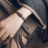 Close wrist view of polished black obsidian beads on the Fu Mo Xuan Tong bracelet