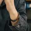 Fu Mo Yun Lei bracelet brass spiral charm shown on the wrist