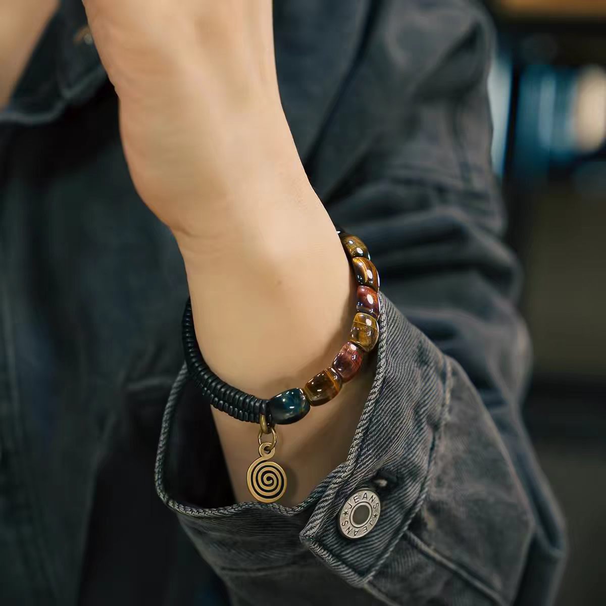 Fu Mo Yun Lei bracelet brass spiral charm shown on the wrist