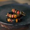Stacked display of Fu Mo Yun Lei multicolor tiger eye bracelets