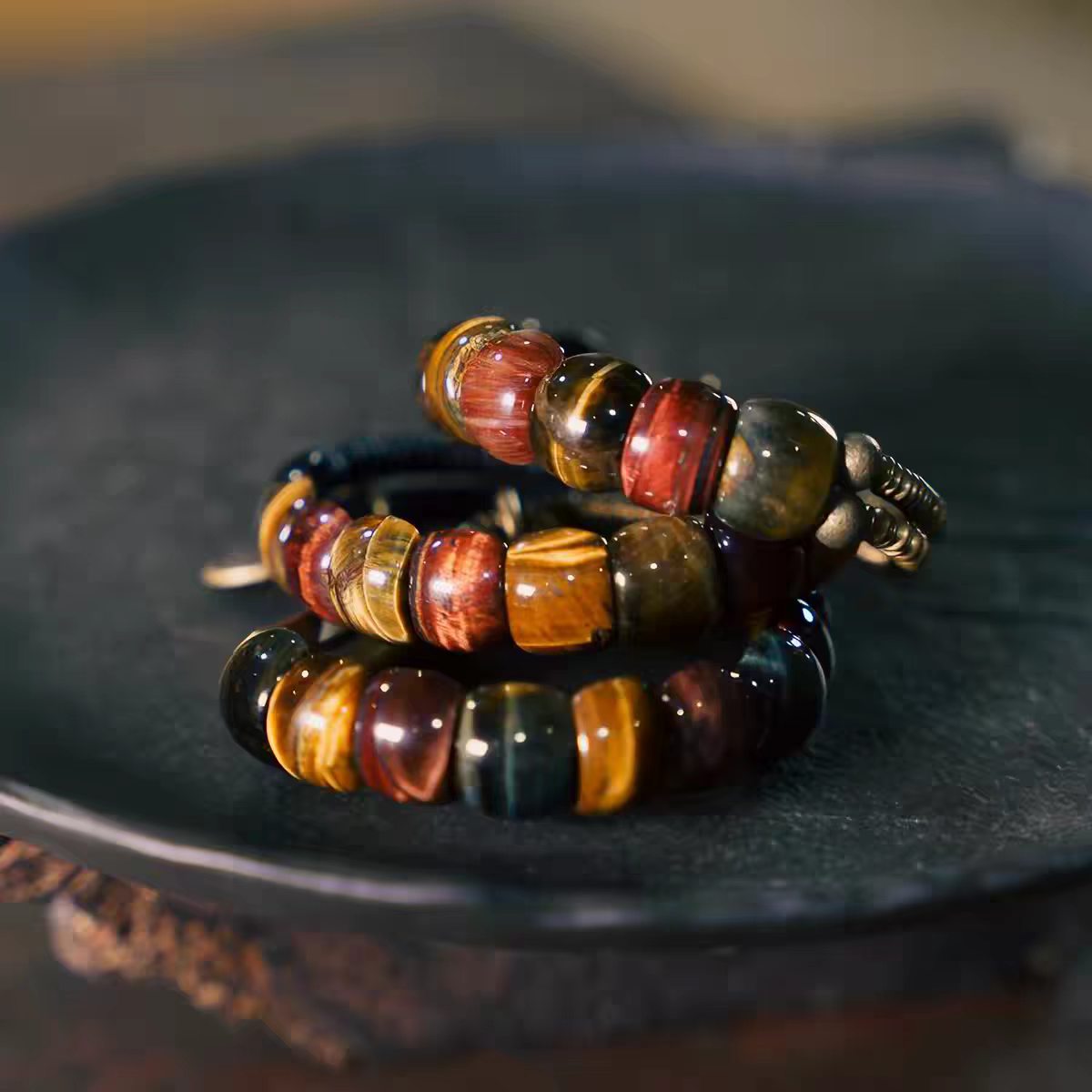 Stacked display of Fu Mo Yun Lei multicolor tiger eye bracelets