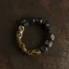 Top view of the circular Style A ebony wood and interwoven brass knot bracelet