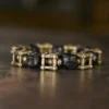 Close-up of a square cage brass knot with faceted ebony beads on the Hunyuan Panjie bracelet