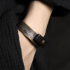 Tai Su Xuan Mu brass and ebony open cuff bracelet worn on the wrist
