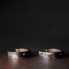 Two Tai Su Xuan Mu bracelets showing natural variations in mottled brass patterns