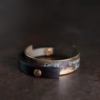 Front detail of Tai Su Xuan Mu mottled brass and ebony cuff bracelet