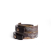 Stacked display of Tai Su Xuan Mu mottled brass and ebony cuff bracelets