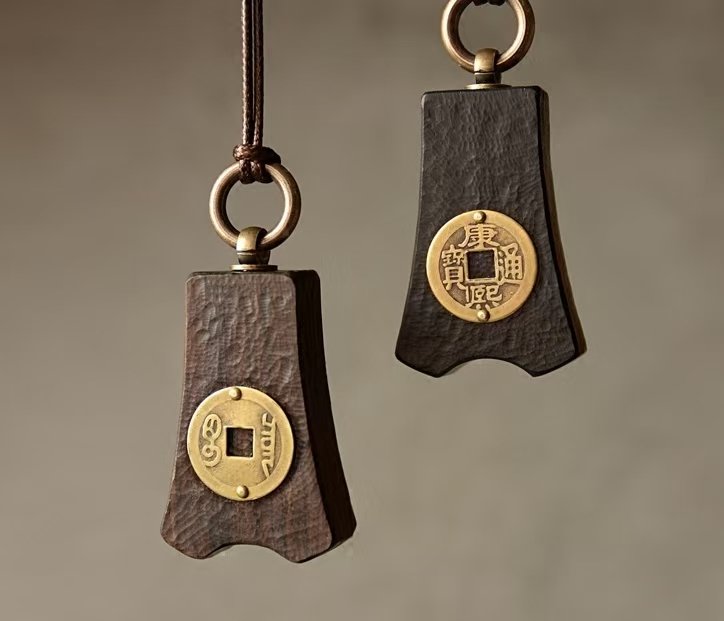 Bao Pu Qian (Embracing Simplicity Coin) Pendant — two pendant necklaces showing different coin faces