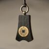 Bao Pu Qian (Embracing Simplicity Coin) Pendant — close view of one dark pendant with a coin motif