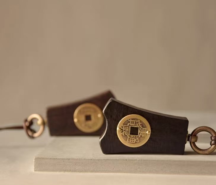 Bao Pu Qian (Embracing Simplicity Coin) Pendant — two pendants laid horizontally showing opposite coin faces