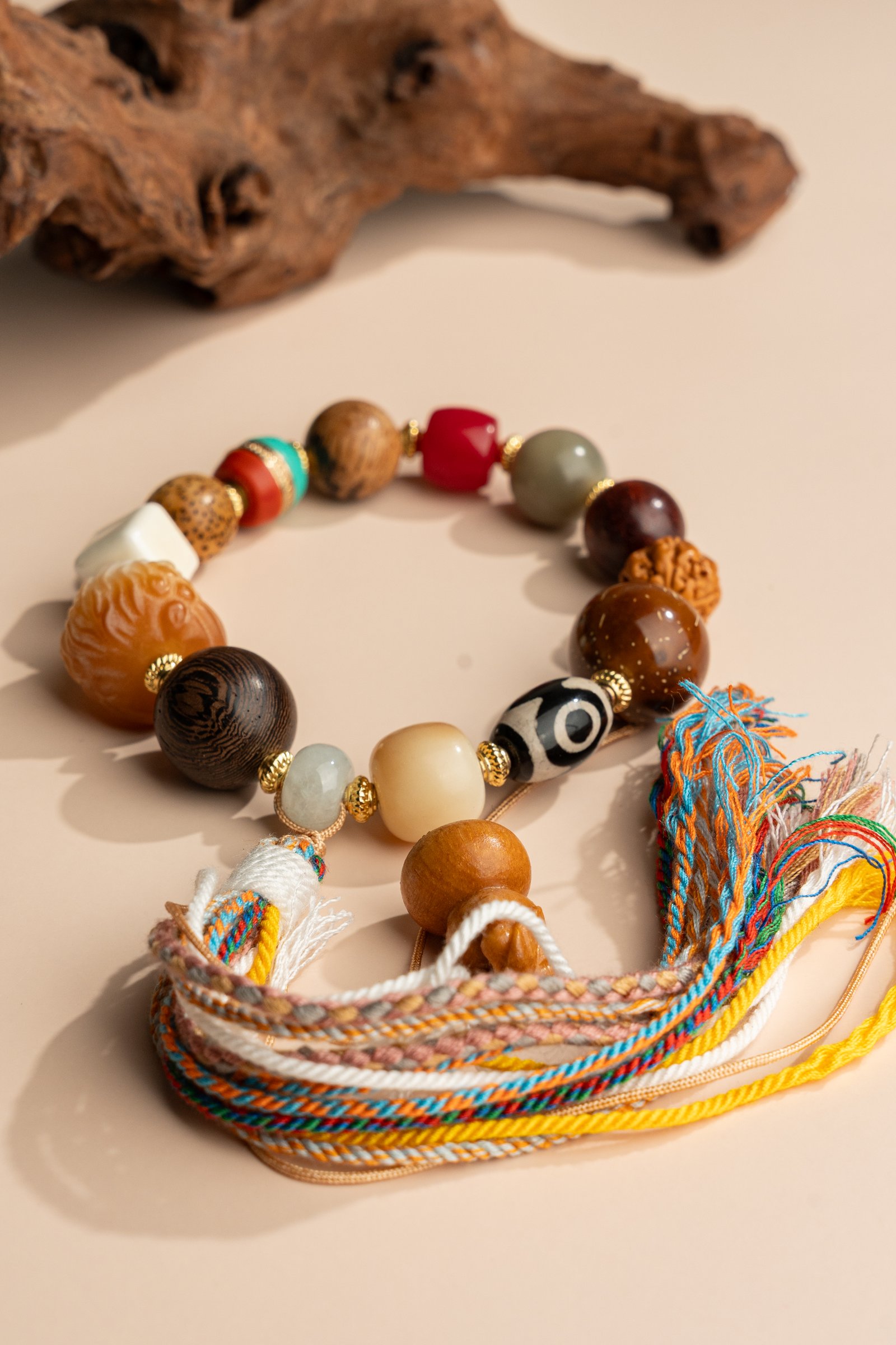 Bodhi Seed, Sandalwood & Dzi Bead Bracelet — close view of the beads and multicolored tassels