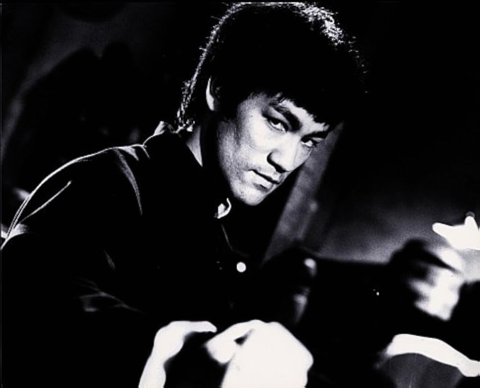 Black-and-white portrait of a man in a martial arts pose