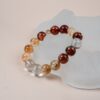 Chinese Zodiac Ox Bracelet — orange and red bead bracelet against a pale display