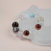 Chinese Zodiac Rooster Bracelet — multicolored bead bracelet against a pale display