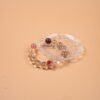 Chinese Zodiac Sheep Bracelet — pale bead bracelet resting on a clear dish