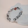 Chinese Zodiac Snake Bracelet — clear patterned bead bracelet against a pale display