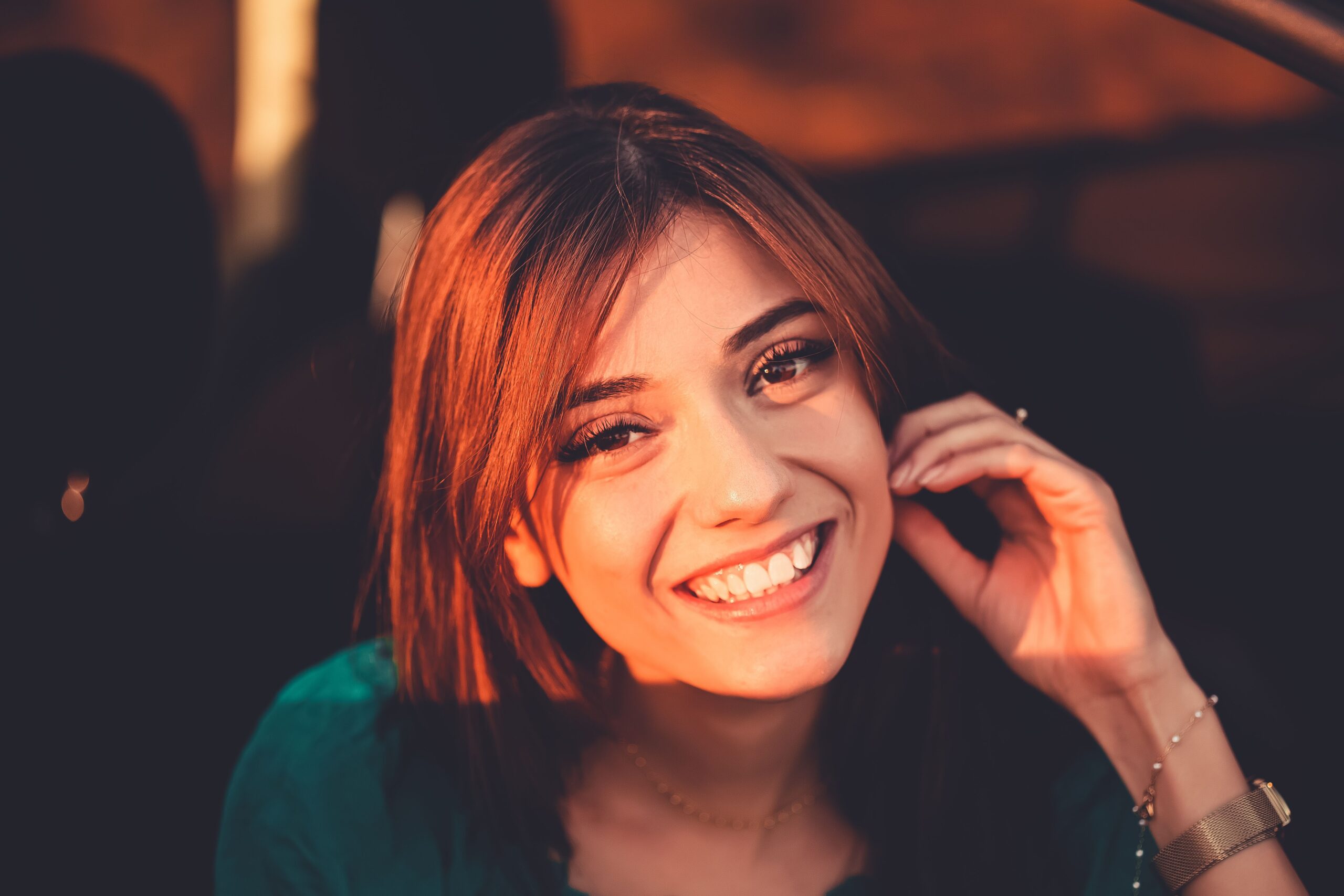 Smiling person holding a phone to their ear