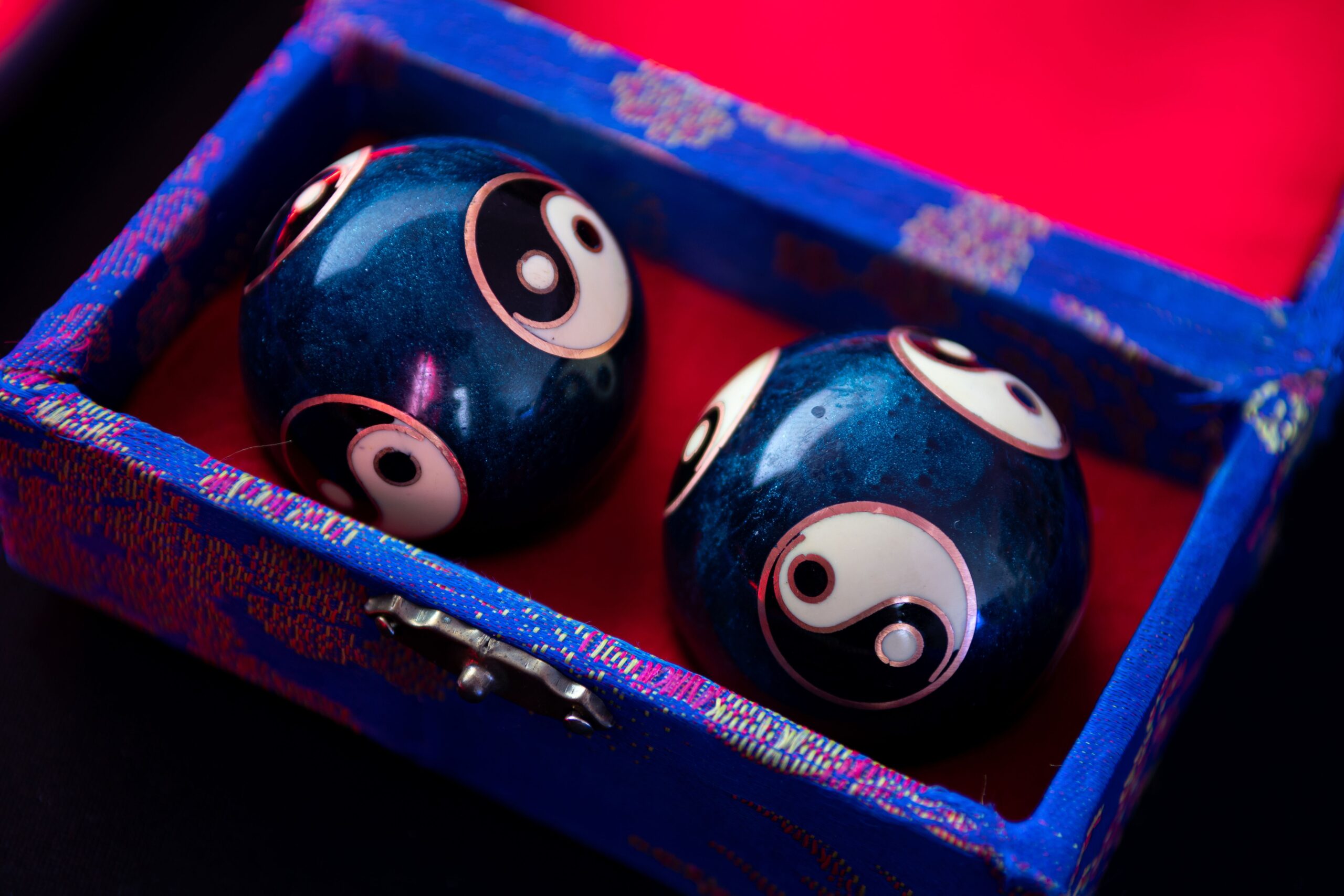 Two dark balls with Yin-Yang designs in a box
