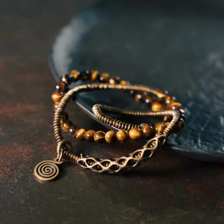 Double Light Bracelet — layered bead bracelet with metallic links and a spiral charm