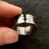 Five Gods of Wealth 999 Silver Gilded Ring — ring held between fingers showing the open band ends