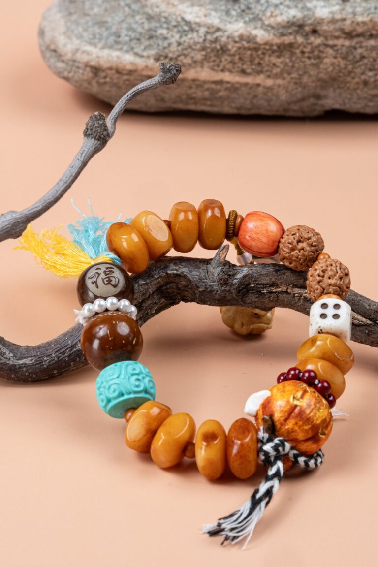 Fuling Agarwood & Bodhi Bead Bracelet — orange-toned bead bracelet with multicolored tassels around a branch