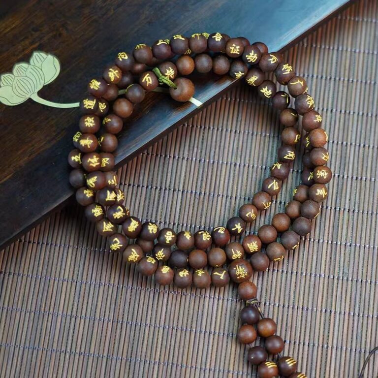 Golden Lightning Wood Taoist Prayer Beads — coiled dark bead strand with gold-colored inscriptions