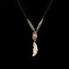 Golden Snake & Fang Pendant — pale curved pendant with gold-colored snake-shaped decoration