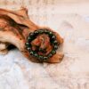 Green Incense Ash Liuli Bead Bracelet — green bead bracelet arranged around wood