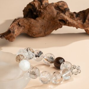 Ink-Wash Phantom Quartz Bracelet — translucent bead bracelet on a pale support