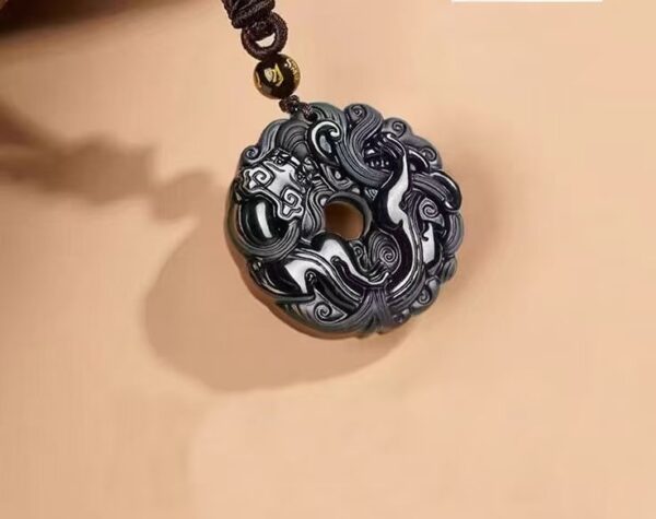 Pixiu Jade Pendant — dark carved circular pendant with a central opening