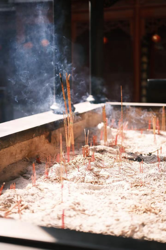 Sacrificial incense burns in the incense burner.