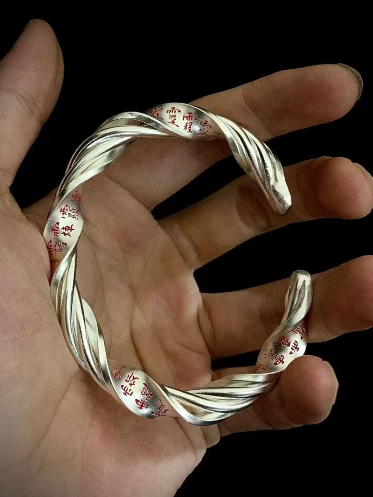 Thirty-Six Heavenly Generals 999 Silver Twisted Bracelet — twisted open cuff bracelet resting in a palm