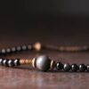 Vintage Floral Layered Obsidian Bracelet — close view of a large dark bead and surrounding small beads