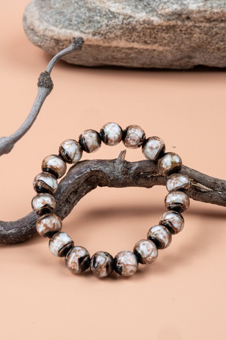 White Incense Ash Liuli Bead Bracelet — black and white patterned bead bracelet around a branch