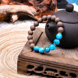 Wuzhen Herbal Incense Bracelet — brown and bright blue bead bracelet beside a teapot
